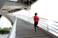 Athletic Woman Running Up Stairs During Cardio
