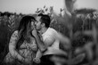 © Serena Burroughs/Stocksy - Black and white image of couple kissing in field