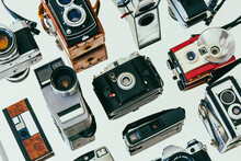 Collection Of Vintage Film Cameras Arranged On A Mirror Diagonally 