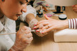 © Olga Moreira/Stocksy - Female nail artist doing nail design
