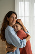 © DimaBerlin - Portrait of happy mother and teenage girl daughter cuddling hugging and smiling at camera, spending time at home, mom and adolescent kid having healthy, supportive relationships. Happy teen parenting