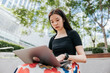 © Heng Yu/Stocksy - Businesswoman  working on a laptop outdoor