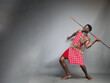 A furious Masai moran warrior about to throw a spear.Huge blank mockup space.Grey background.Copy text and paste 