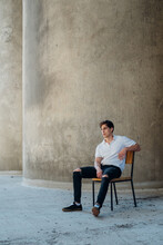 Cool Young Male Model Sitting On Chair
