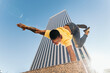 © Pedro Merino/Stocksy - Gymnast doing a handstand in an urban area with skyscrapers