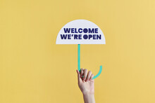 "Welcome We're Open" On Cafe Or Restaurant Hang On Door At Entrance.