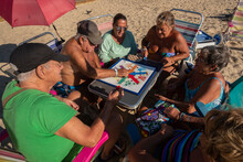 A Group Of Retirees Playing A Board Game .