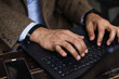 © Ana Luz Crespi/Stocksy - Latino business man hands in keyboard close up