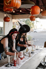Friends In Costume Enjoy Decorating Fall Table