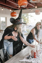 Friends In Costume Decorate Fall Outdoor Table