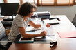 © Lightsy/Stocksy - Brunette and grey hair businesswoman working