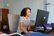 © Lightsy/Stocksy - Brunette businesswoman working on a computer