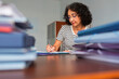 © Lightsy/Stocksy - Woman working surrounded by files