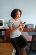 © Lightsy/Stocksy - Woman using a cell phone in the office