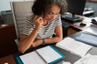 © Lightsy/Stocksy - Woman looking at documents while she is on the phone