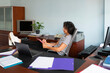 © Lightsy/Stocksy - A woman reviewing documents at work