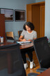 © Lightsy/Stocksy - Woman taking notes at work