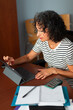 © Lightsy/Stocksy - Woman working on a tablet in the office
