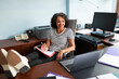 © Lightsy/Stocksy - Smiley lawyer working in the office