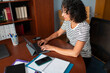 © Lightsy/Stocksy - Woman working on a tablet in the office