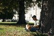 © Pedro Merino/Stocksy - Young man working and studying with laptop outdoors