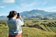 Woman Taking A Picture Of The Landscape