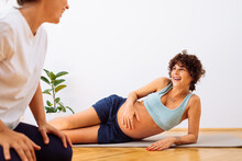 Pregnant Woman Exercising With Instructor 