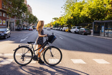 Young Hispanic Woman With Bike On Road