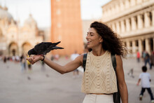 A Woman Have Fun With Pigeon Birds In Venice