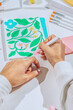 © AUDSHULE/Stocksy - Illustrator drawing floral designs.