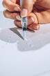 © AUDSHULE/Stocksy - hand holding brush pen
