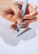 © AUDSHULE/Stocksy - hand holding brush pen