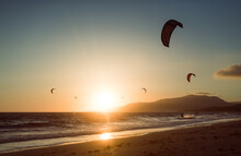 Group Of Kite Surfers Silhouettes At The Beach 
