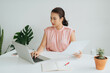 © Marc Tran/Stocksy - female marketing manager is working in the office,