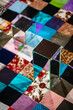 © Dima Sikorski/Stocksy - Conceptual still life with patchwork quilt and mirrors