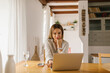 © STUDIO TAURUS/Stocksy - Woman using laptop at home