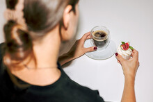 A Young Woman Admires Her Muffin With Cream And Figs With Coffee