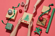 © Marc Tran/Stocksy - Female hands wrapping christmas gift box above red background