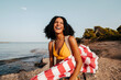 © Lucas Ottone/Stocksy - Portrait of a traveler woman laughing