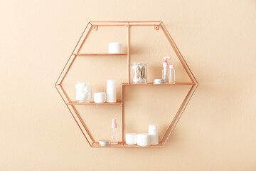 Wall Mural - Shelves with container of soft cotton wool, swabs and cosmetic bottles on beige wall