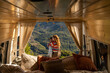 © Alba Vitta/Stocksy - Hugging couple hwith camper van in nature
