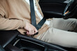 © Marc Tran/Stocksy - Handsome man putting on her safety seatbelt before starting the car