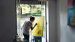© Pedro Merino/Stocksy - Artist painting a canvas near a balcony in a studio