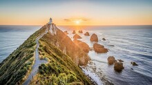 Nugget Point Lighthouse On A Cliff Surrounded By The Sea During A Beautiful Sunrise In New Zealand