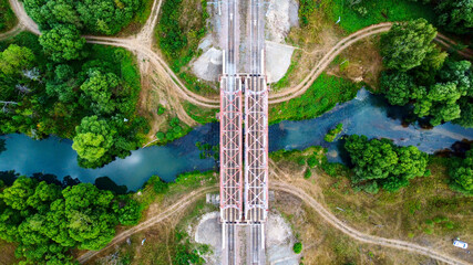 railway bridge over a small river close-up view from above, bright colorful photo