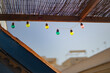 © Lydia Cazorla/Stocksy - Colored twinkling lights hanging from a terrace