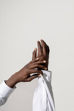 A Hand In A Shirt On A Gray Background