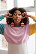 © BONNINSTUDIO/Stocksy - Playful woman with Xmas bauble earrings