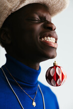 Playful Black Guy With Bauble In Teeth