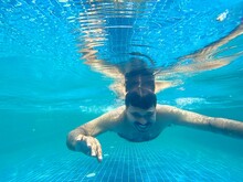 Middle Aged Indian Man Swimming In A Swimming Pool 